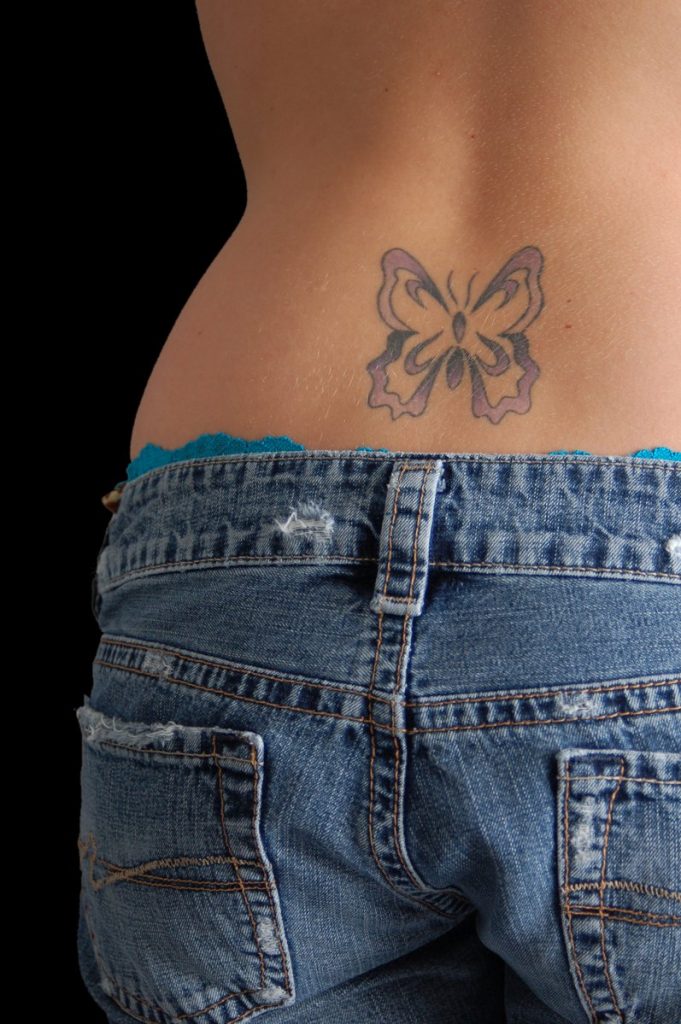 A sick A F Lower back tatty. A butterfly T S with purple and black.