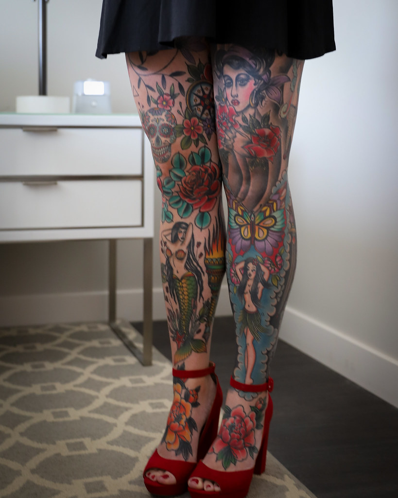 legs fully tattooed with colorful american traditional tattoos