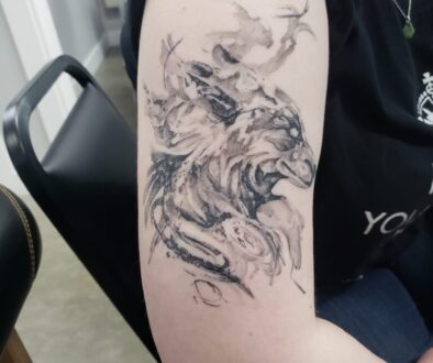 Black and white watercolor tattoo wolf design